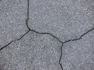 sealcoat and fill cracks in asphalt pavement